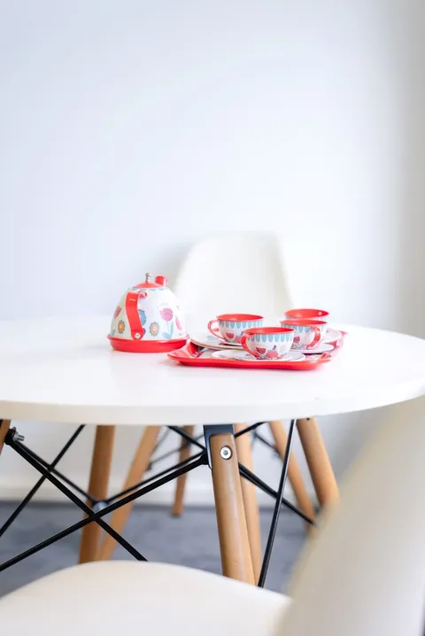 Children’s table set with a colourful toy tea set