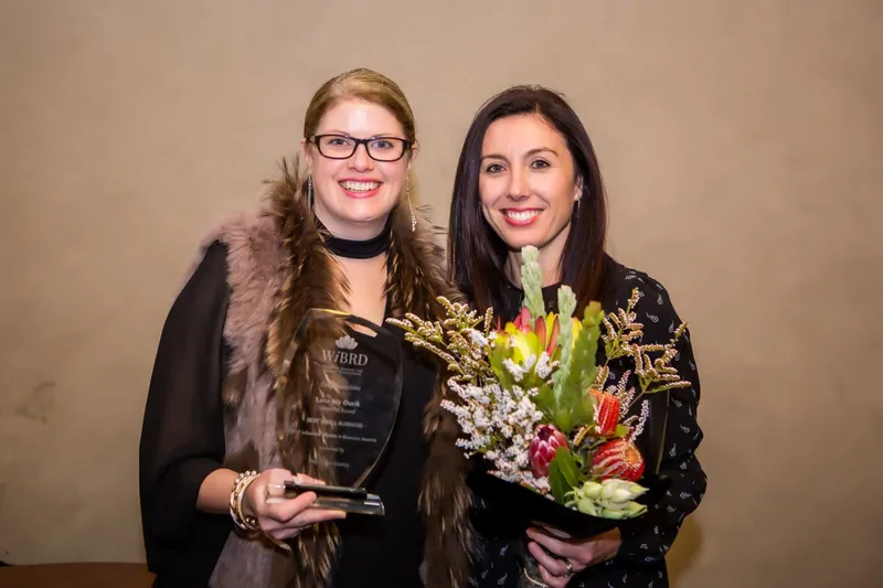 Lana-Joy Durik celebrating the WIBRD Best Small Business award with a fellow attendee